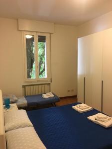 a room with two beds and a window at Procaccini Apartment in Bologna