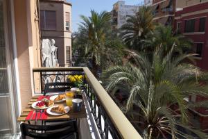 Un balcón con una mesa con comida. en Valencia Modern Beach Apartment, en Valencia