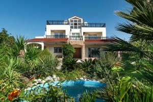 a house with a swimming pool in front of it at Royal Classico Villa in Kolymbia
