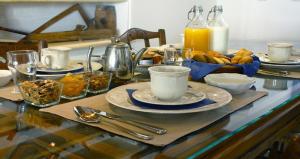 a table with plates of food and drinks on it at Villa Kardiani in Kardhianí