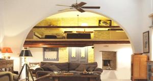 a living room with a couch and a ceiling fan at Villa Kardiani in Kardhianí