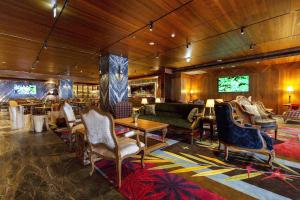 a living room with chairs and a couch and tables at Inhouse Hotel Grand in Taichung