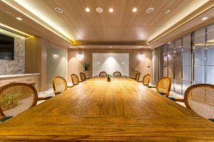 a conference room with a large wooden table and chairs at Inhouse Hotel Grand in Taichung +64 photos