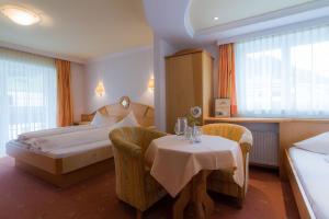 Posteľ alebo postele v izbe v ubytovaní Hotel Garni Martina