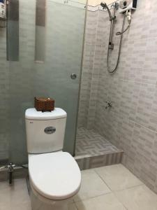 a bathroom with a toilet and a shower at Moon house tropical garden - West side in Nha Trang