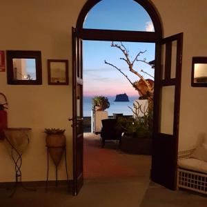 an open door to a room with a view of the ocean at La Sirenetta Park Hotel in Stromboli