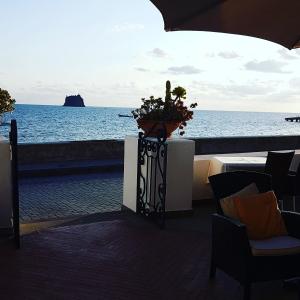 a view of the ocean from a patio with a plant at La Sirenetta Park Hotel in Stromboli
