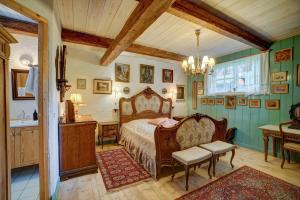 a bedroom with a bed and two chairs in a room at Svostrup Kro in Silkeborg