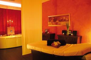 a room with a bed and a bath tub at Morada Strandhotel Ostseebad Kühlungsborn in Kühlungsborn