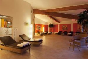 a waiting room with couches and chairs in a building at Morada Strandhotel Ostseebad Kühlungsborn in Kühlungsborn