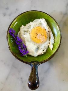 a fried egg in a green bowl with a spoon at Le Domaine Saint Jean in Saint-Saturnin-les-Apt +34 photos
