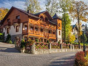 a large wooden house on a brick street at Willa Pokusa in Szczawnica