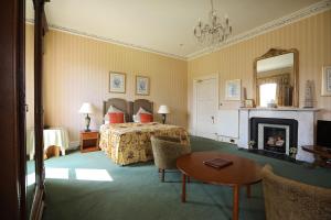 a hotel room with a bed and a fireplace at Kingsknowes Hotel in Galashiels
