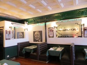 a dining room with two tables and a mirror at The Polo Inn Bridgeport U.S.A. in Chicago