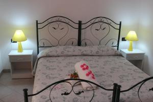 カストロ・ディ・レッチェにあるAmoru Bed & Breakfastのベッドルーム1室(ベッド1台、ナイトスタンド2台、ランプ2つ付)
