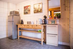 a kitchen with a table and a refrigerator at Wohnung 2 in Eschweiler