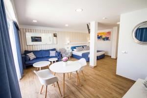 a hotel room with a bed and a table and chairs at IG Nachosol Atlantic & Yaizasol by Servatur - Adults Only in Puerto Rico de Gran Canaria
