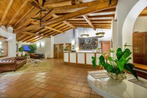 a large living room with a ceiling with wooden beams at Hotel Sporting in Porto Rotondo