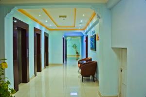 a corridor of a hospital with a chair in a corridor at Al Maha Int Hotel Oman in Muscat