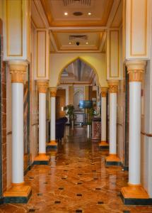 an empty hallway with columns in a building at Al Maha Int Hotel Oman in Muscat
