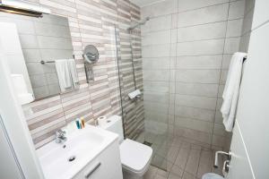 a bathroom with a toilet and a sink and a shower at IG Nachosol Atlantic & Yaizasol by Servatur - Adults Only in Puerto Rico de Gran Canaria
