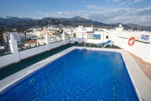 a swimming pool on the roof of a building at Hotel Bajamar Centro in Nerja