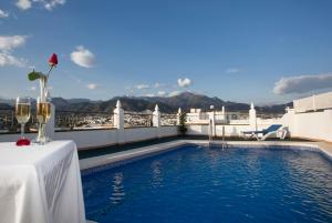 a swimming pool on the roof of a building at Hotel Bajamar Centro in Nerja