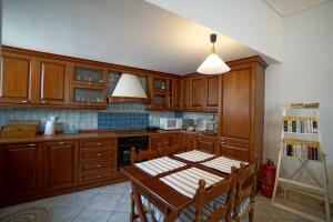 a kitchen with a table and a refrigerator at Seafarer's Suite by Filos Inc in Galaxidi