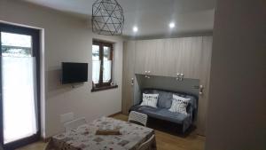 a living room with a couch and a table at La casa degli gnomi in Riva Valdobbia
