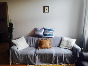 a pile of pillows sitting on a blue couch at Stylish apartment with sauna in Kuressaare