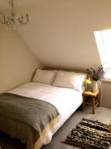 1 dormitorio con cama y lámpara de araña en The Loft, en Pilton