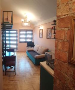 ein Wohnzimmer mit einem Sofa und einem Tisch in der Unterkunft Bolonja in Užice