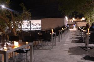 a row of tables and chairs at a restaurant at night at Casa rural Vistas al Rio in Jorquera