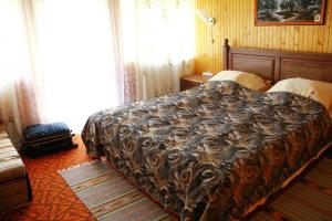 a bedroom with a bed with a blanket on it at у андрія in Yaremche
