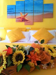 a bedroom with a bed with sun flowers on it at Stella Marina in Camogli