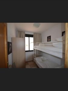 a bedroom with two bunk beds and a window at Calle Cinteria in Málaga +6 photos