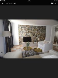 a living room with a couch and a stone fireplace at Calle Cinteria in Málaga