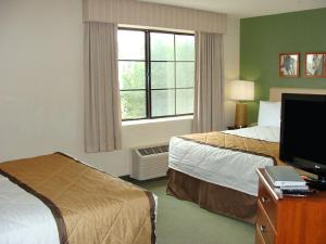 a hotel room with two beds and a television at Extended Stay America Suites - Cleveland - Middleburg Heights in Middleburg Heights