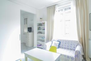 a small living room with a couch and a window at Central cosy apartment in Bologna