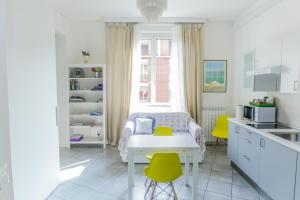 a kitchen with a table and yellow chairs in a room at Central cosy apartment in Bologna