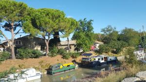 a group of boats docked in a river at atmosphere in Poilhès