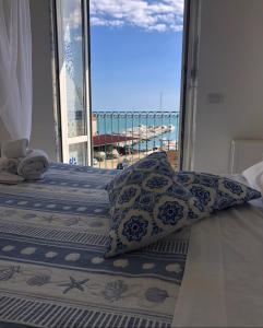 a bedroom with two beds with a view of the ocean at Relais Mareluna - Luxury Apartments in Salerno
