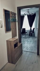 a living room with a table and a mirror at Apartment Valerie walking distance to Top Center in Plovdiv