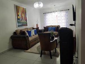 a living room with a couch and a table at Ave. Duarte k3/12, Residencial Palma Real, Santiago, RD in Arenoso