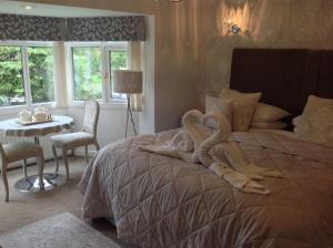 a bedroom with a large bed with a snake on it at Oakleigh house in Stratford-upon-Avon