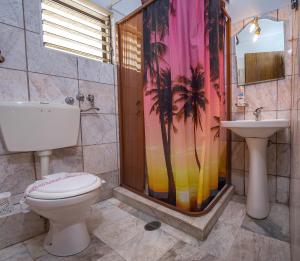 a bathroom with a shower and a toilet and a sink at Kostas Studios in Skala Marion +41 photos