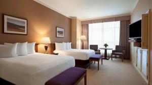 a hotel room with two beds and a tv at Harrah's Joliet Casino Hotel in Joliet