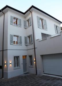a large white building with a garage at OFFICINA TESINI Guest Rooms Verona in Verona