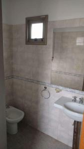 a bathroom with a sink and a toilet at Departamento Ludmila in Villa María