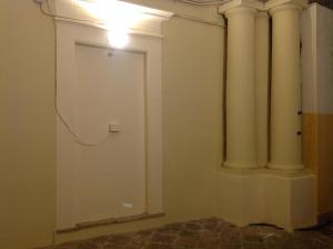 a room with a white door and a pillar at Terrazze Bella Epoque in Acireale